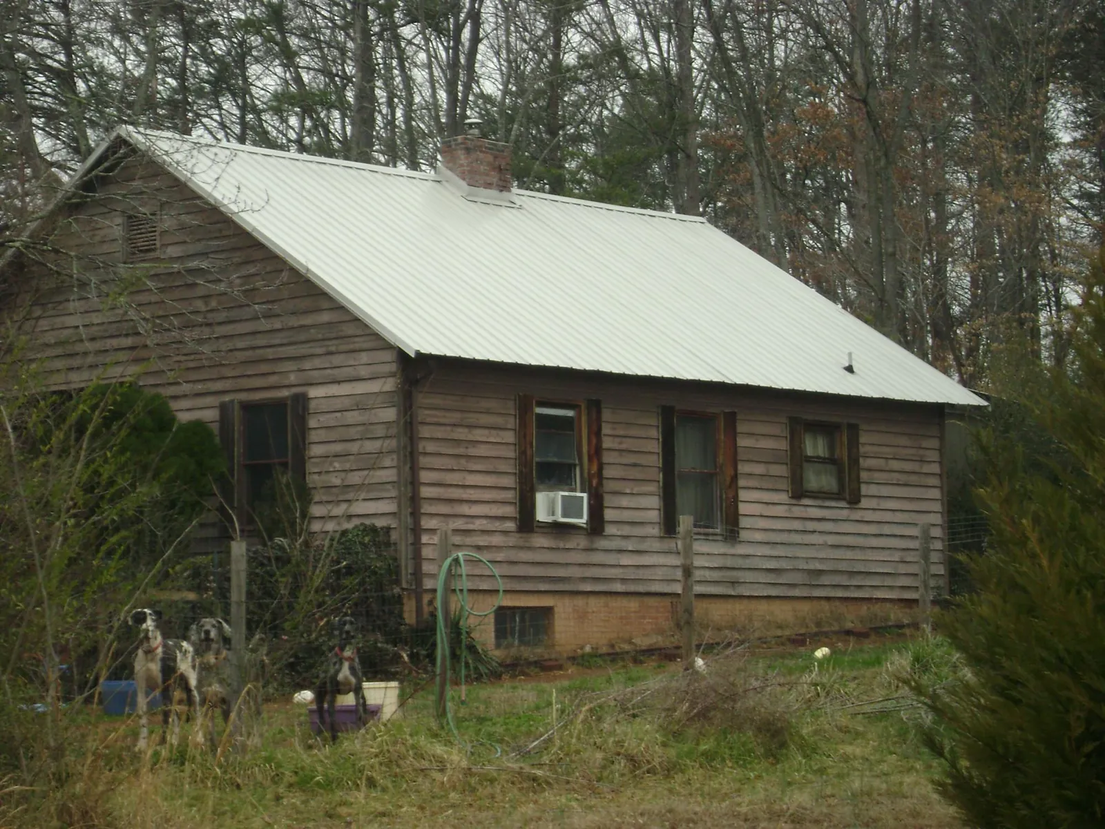 White metal roof on an old wood sided farmhouse, from a Asphalt Shingle Roof Repair job in Beale Afb